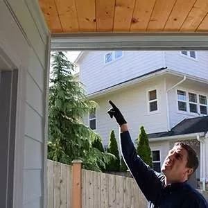man checking out ceiling